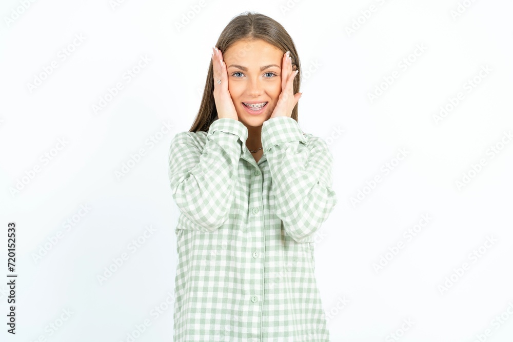Young beautiful woman standing over white studio background Pleasant looking cheerful, Happy reaction Young beautiful woman standing over white studio background Pleasant looking cheerful, Happy reaction