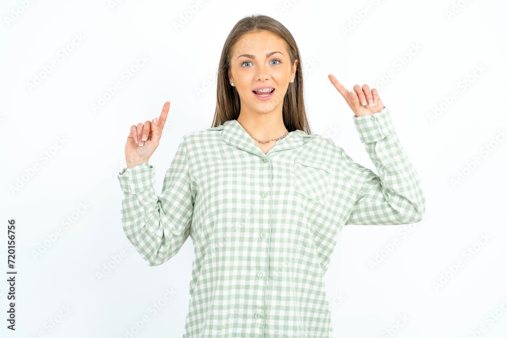 Cheerful young beautiful woman wearing green plaid pyjama, demonstrating hairdo Cheerful young beautiful woman wearing green plaid pyjama, demonstrating hairdo