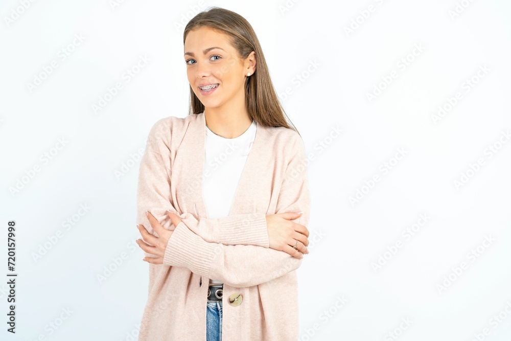 Portrait of charming Young beautiful woman standing confidently smiling toothily with hands folded Portrait of charming Young beautiful woman standing confidently smiling toothily with hands folded