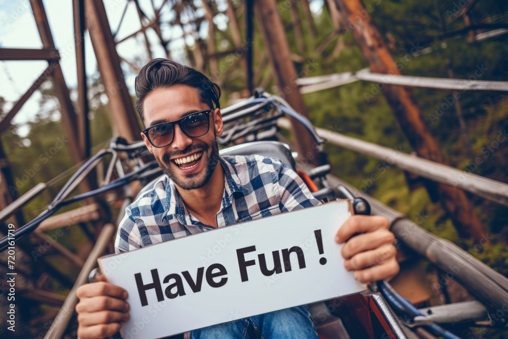 Have fun concept image with a young man having fun in a rollercoaster ...