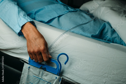 man wearing a urine drainage bag in bed photo