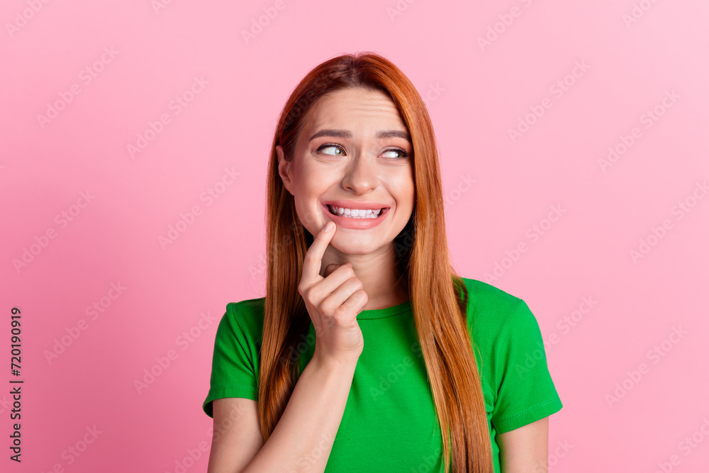 Photo of confused woman with ginger hair dressed green t-shirt look at stomatology ad empty space isolated on pink color background Photo of confused woman with ginger hair dressed green t-shirt look at stomatology ad empty space isolated on pink color background