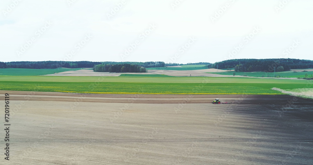 Agricultural background of farmer using tractor