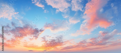 Scenic panorama evening sky with blue, white and orange clouds