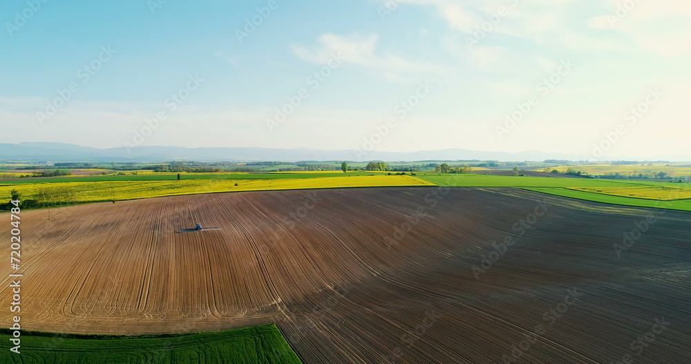 Aerial shoot of tractor working on field. AGRICULTURE. Aerial shoot of tractor working on field. AGRICULTURE.