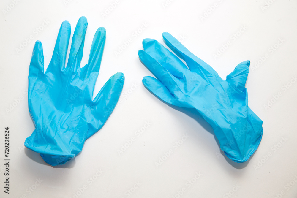 Hands wearing blue medical surgical gloves Hands wearing blue medical surgical gloves