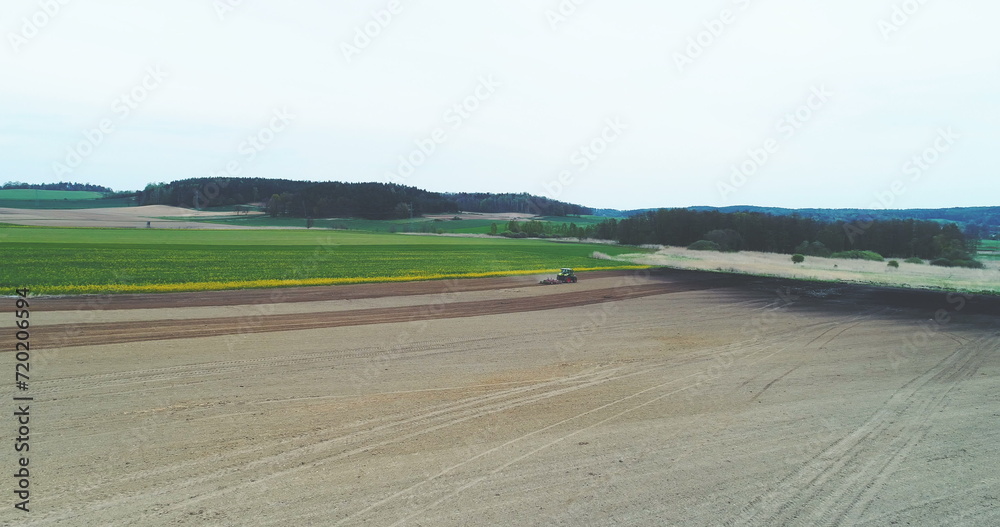 Tractor Plowing Field in spring.