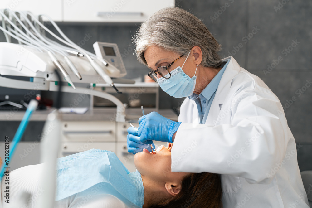 A dentist working in the office. A dentist working in the office.