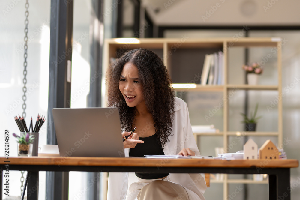 Black businesswoman stressed with busy work, Online meetings are stressful. Work planning does not meet goals, Dissenting opinions Black businesswoman stressed with busy work, Online meetings are stressful. Work planning does not meet goals, Dissenting opinions