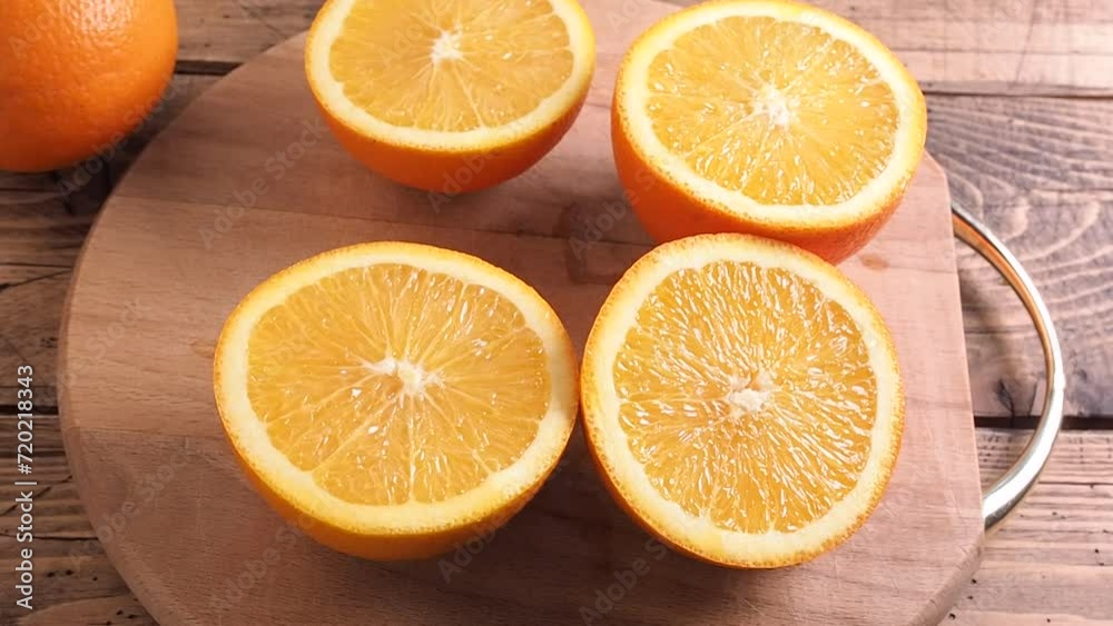 Slices of fresh orange on a wooden cutting board. A healthy citrus fruit. Slices of fresh orange on a wooden cutting board. A healthy citrus fruit.