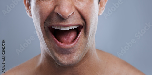 Man, mouth and clean shave with laughing, lips and hygiene with jawline, satisfaction and treatment closeup. Grooming, confidence and face with male model in studio background for cosmetic smile photo
