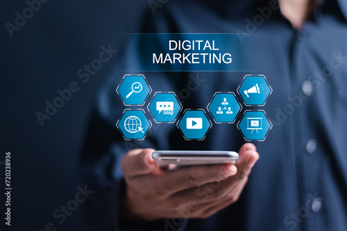 Person use smartphone with displays digital marketing icons for digital marketing commerce online sale concept, website ad, email, social network, video, SEO and business strategy.