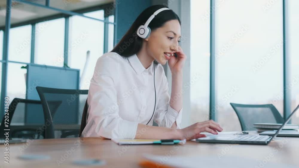Technical support. In headphones. Businesswoman is indoors in the office. Technical support. In headphones. Businesswoman is indoors in the office.