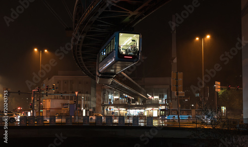 Obraz na płótnie Night cityscape of Wuppertal, North Rhine-Westphalia, Germany: Schwebebahn cable car (electric elevated suspension monorail) at Alter Markt, Barmen city district w salonie