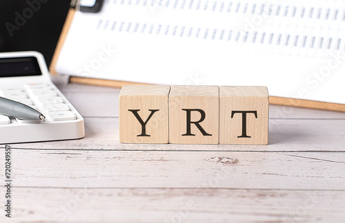 YRT word on a wooden block with clipboard and calcuator photo