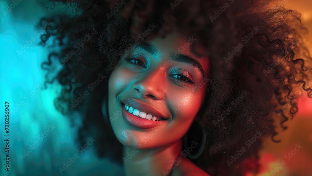 A beautiful African-American girl with a lush hairstyle is laughing A beautiful African-American girl with a lush hairstyle is laughing