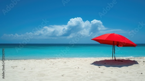 A picturesque beach scene with a vibrant red parasol  soft white sand  and crystal blue waters.
