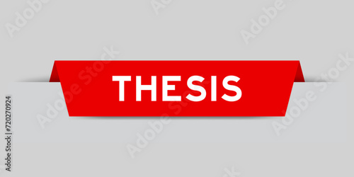Red color inserted label with word thesis on gray background photo
