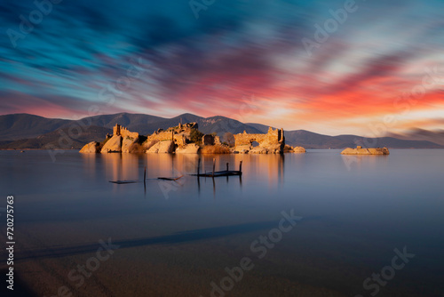 Different views of Bafa Lake in Aegean province of Turkey, boats pier island with monastery and rock forms on a colorful sunset and reflections photo