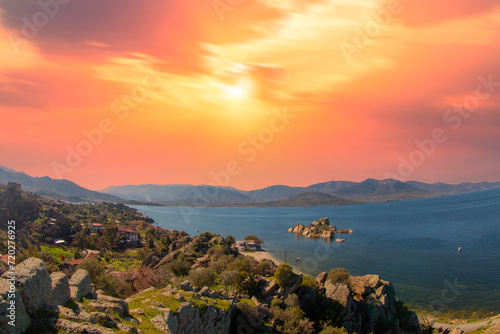 Fototapeta Naklejka Na Ścianę i Meble -  Different views of Bafa Lake in Aegean province of Turkey, boats pier island with monastery and rock forms on a colorful sunset and reflections