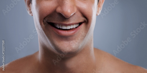 Man, mouth and smile with skincare and lips with hygiene, jawline and satisfaction with treatment closeup. Grooming, confidence and cropped with male model in studio background for cosmetics
