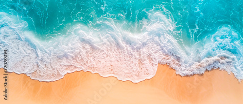 Aerial view sand beach with light blue water waves and sun lights. Summer vacation background