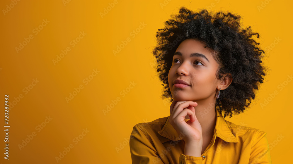 A young woman with curly hair in a contemplative pose A young woman with curly hair in a contemplative pose