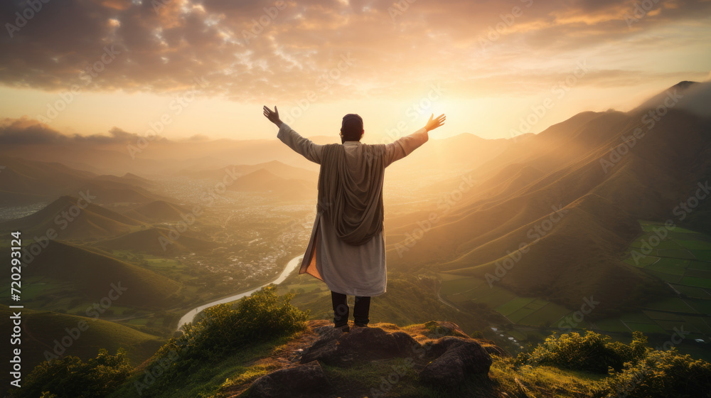 Serene sunrise over hills with man in traditional dress arms wide