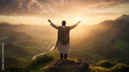 Serene sunrise over hills with man in traditional dress arms wide © Photocreo Bednarek