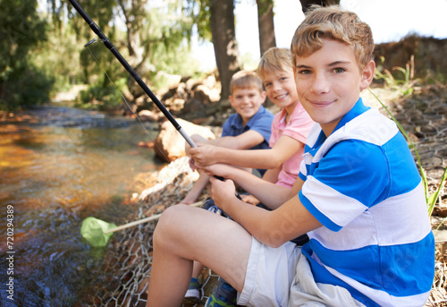 Children, portrait and fishing rod at river in nature for holiday fun at countryside for vacation, learning or travel. Kids, boys and net for catch adventure at lake for teamwork, teaching or relax