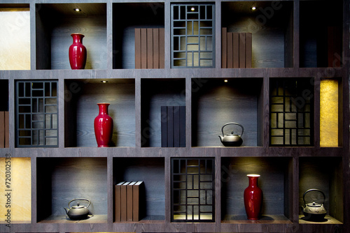 The wooden cabinets on the wall along with various Chinese-style decorations