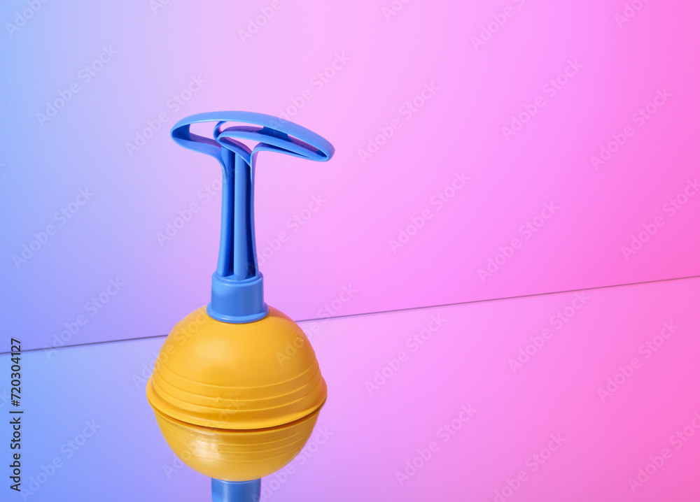 Bright yellow plunger for removing clogs in the toilet or kitchen. Copy space for text. Bright yellow plunger for removing clogs in the toilet or kitchen. Copy space for text.
