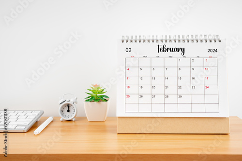 February 2024, Monthly desk calendar for 2024 year on wooden table.