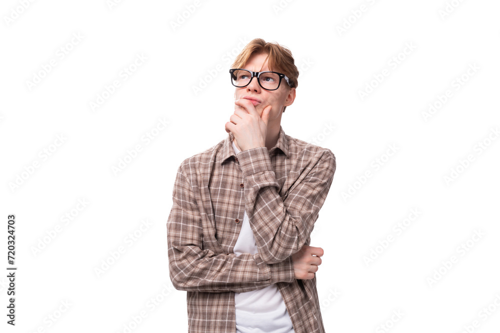 portrait of a young cute caucasian red-haired guy in a shirt on a white background with copy space portrait of a young cute caucasian red-haired guy in a shirt on a white background with copy space