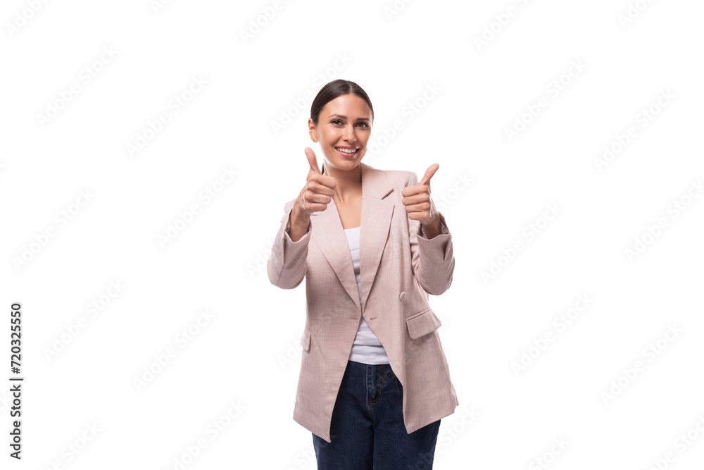 young successful business woman with a ponytail hairstyle is dressed in a beige jacket on a white background young successful business woman with a ponytail hairstyle is dressed in a beige jacket on a white background