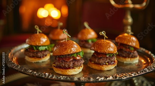 Gourmet mini-burgers elegantly presented on a silver platter.