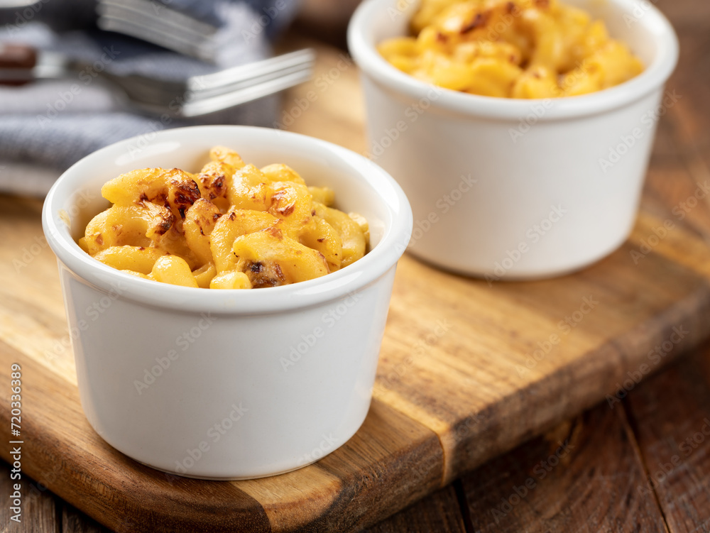 Baked macaroni and cheese in a white cuo Baked macaroni and cheese in a white cuo