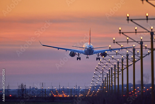Passenger plane is landing during a wonderful sunset