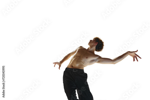 Balance. Young flexible bared man, ballet dancer performing contemporary dance against white studio background. Concept of art, self-expression, human motions, wellness, natural beauty of male body.