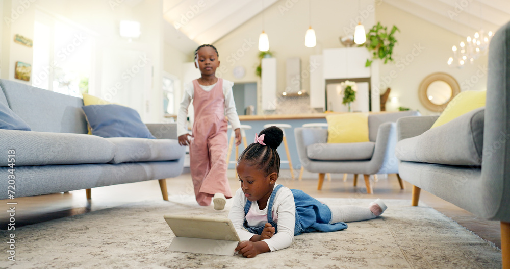 Black girl children on ground with tablet and relax, elearning or watch cartoon movie, sisters at home and screen time. Young female kids, streaming online and subscription to education app or film - obrazy, fototapety, plakaty 