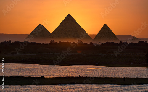 Giza pyramid Complex by the Nile at amazing sunset - Egypt
