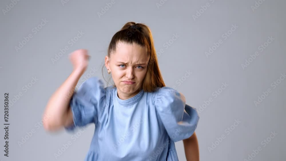 Сapricious offended young woman against gray background Сapricious offended young woman against gray background