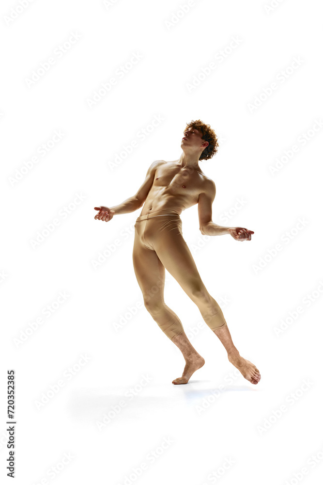 Portrait of shirtless artistic ballet dancer, dancing and demonstrating his athletic body against white studio background. Contemporary ballet. Art, motion, action, inspiration concept. Portrait of shirtless artistic ballet dancer, dancing and demonstrating his athletic body against white studio background. Contemporary ballet. Art, motion, action, inspiration concept.