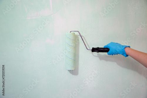 Brush the variegated color paint onto the weathered wooden plank wall