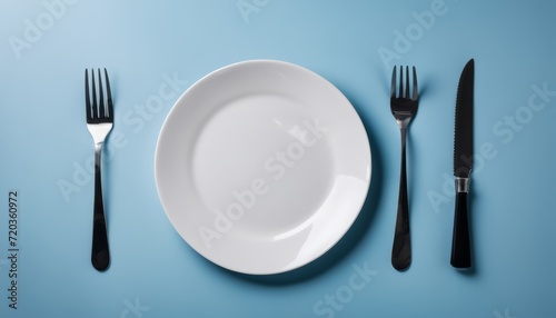 A white plate with a fork and knife on either side