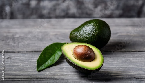 A green avocado with a brown pit inside