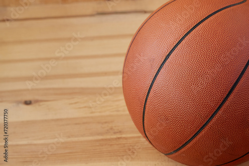 Basketball ball close-up on wooden parquet background. Sports background
