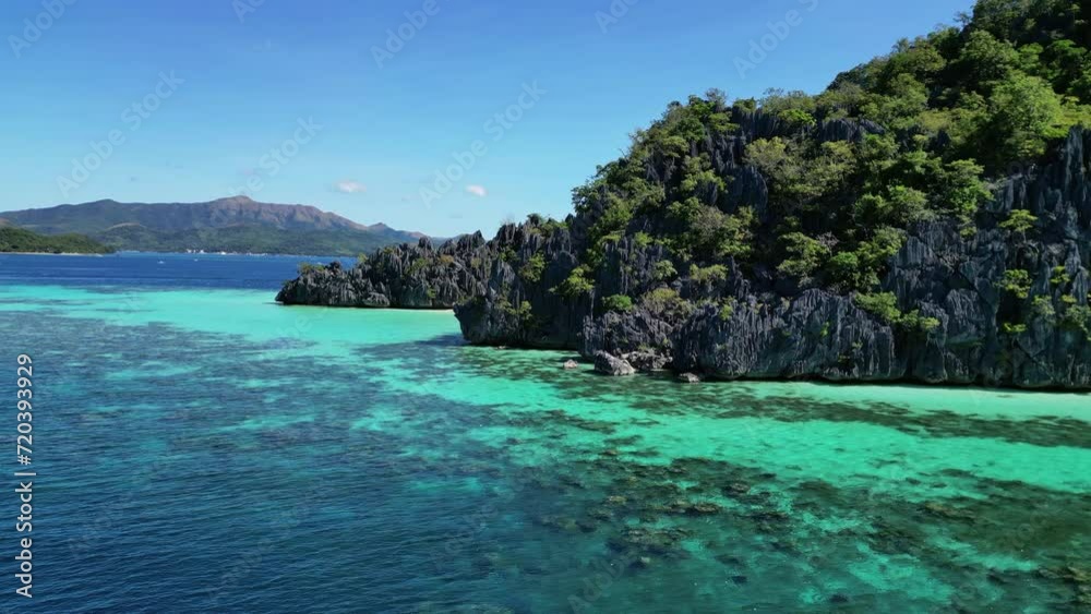 Aerial around view of tropical Philippines island. White sand beach, rocks cliffs mountains with blue bay and beautiful coral reef, 4k Aerial around view of tropical Philippines island. White sand beach, rocks cliffs mountains with blue bay and beautiful coral reef, 4k