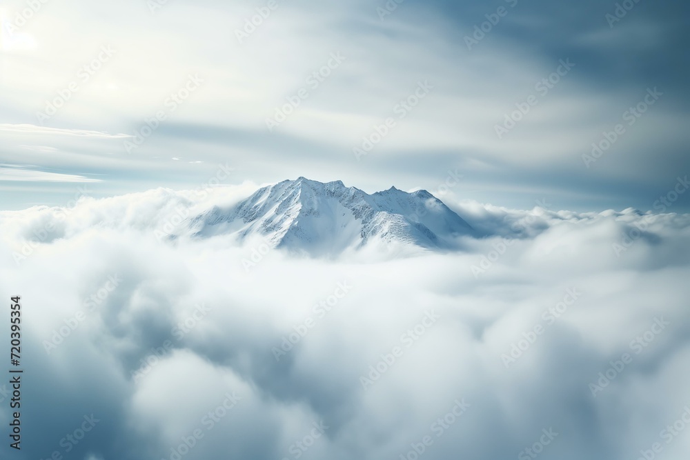 splendid snowy mountain top above the clouds, dramatic sky