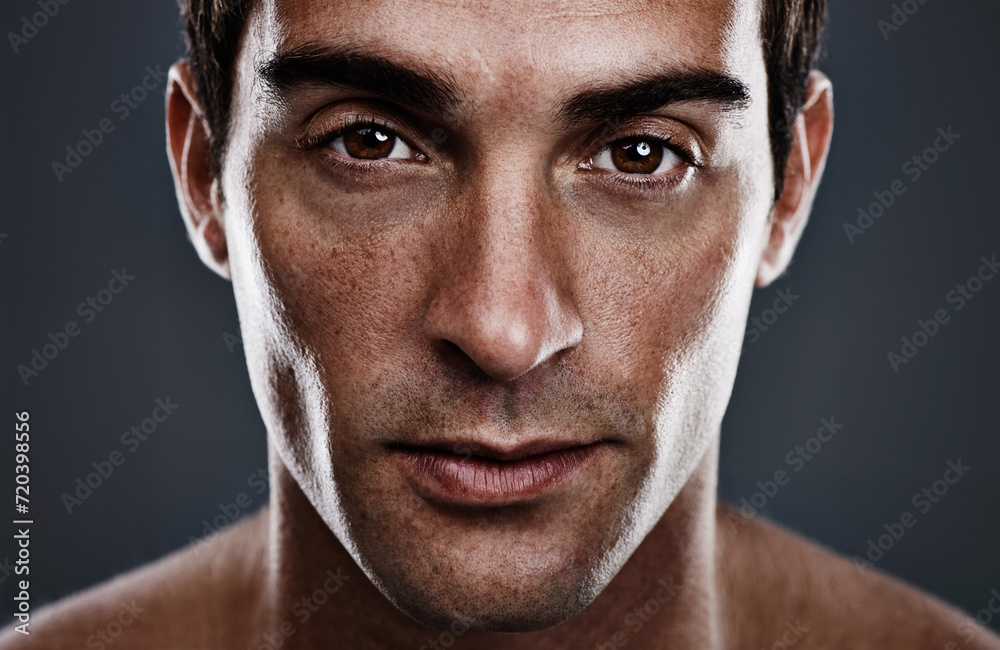 Fototapeta premium Portrait, skincare and man with cosmetics, glow and grooming on grey studio background. Person, guy and model with routine or treatment with beauty and shine with beauty, wellness or dermatology